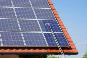 solar panels on rooftop being cleaned